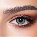 Bella Glow Husky Gray Green Lenses, showing a close-up of a gray-green contact lens with subtle gray flecks.