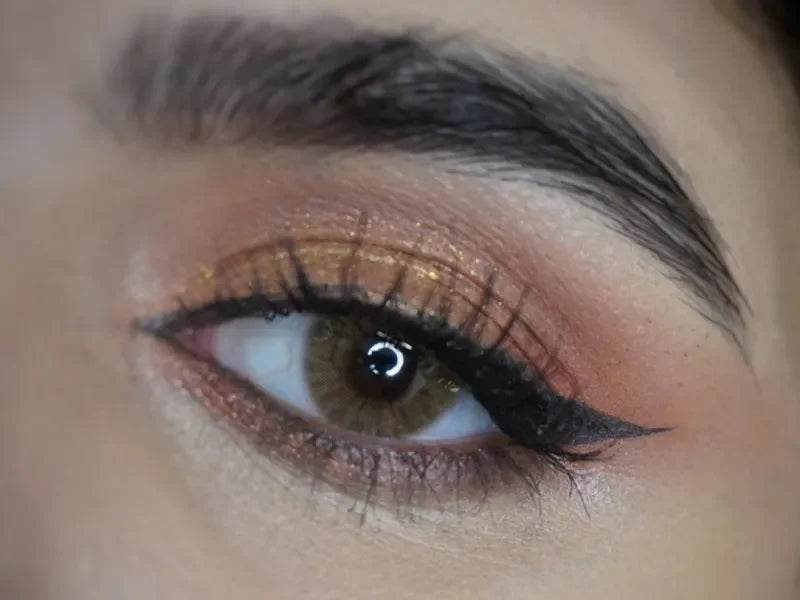 Solenza Desire Agarwood colored contacts, showing a close-up of a brown-toned contact lens with subtle flecks.