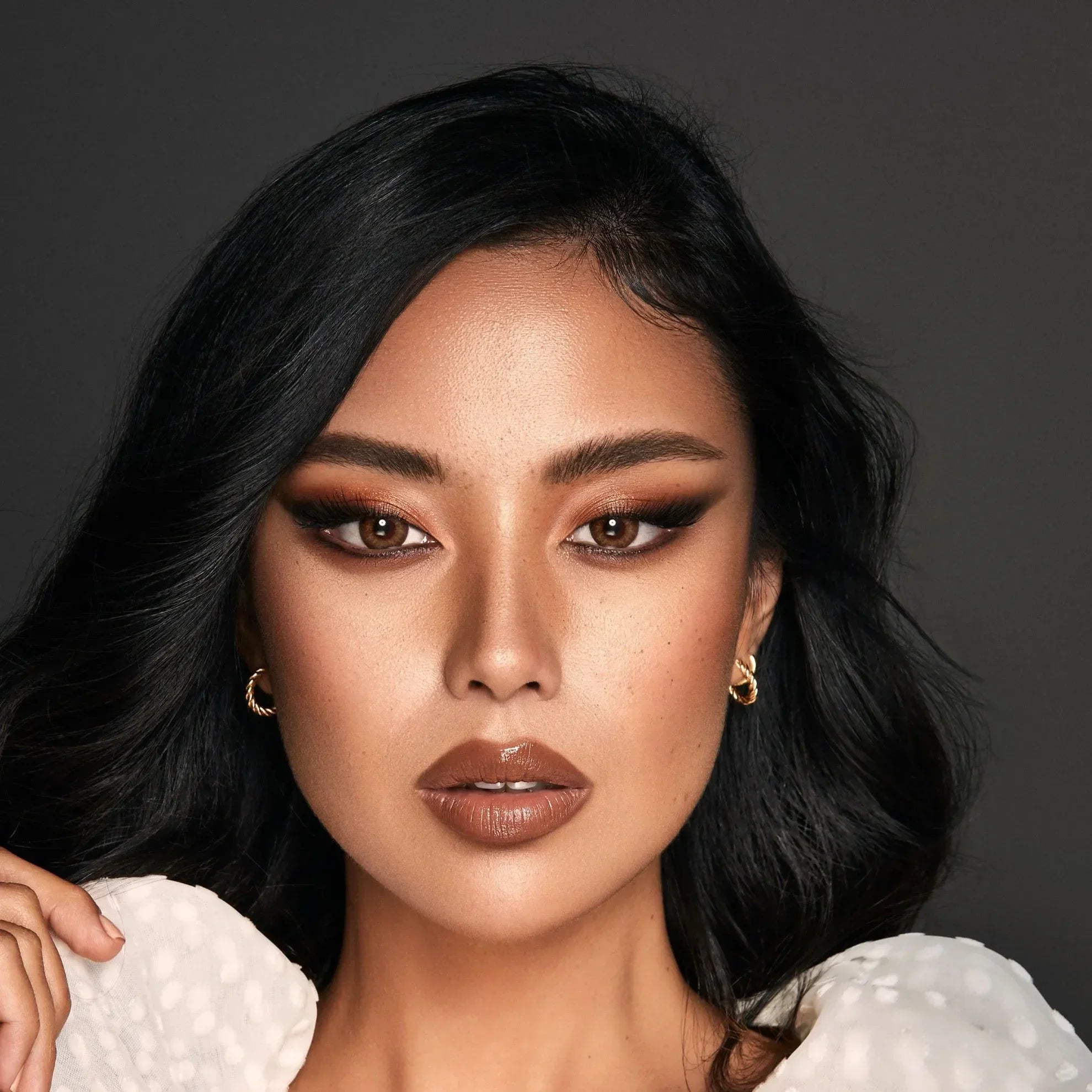 Bella One Day Almond Brown Lenses in their packaging, showcasing the natural brown color.