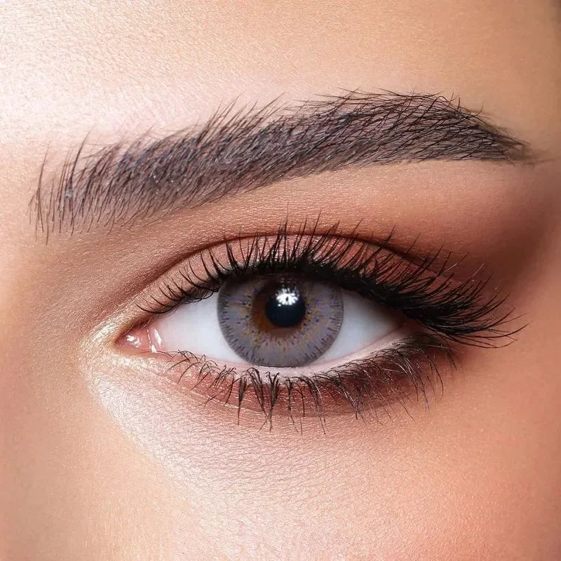 Bella Elite Amber Gray Lenses, a pair of striking gray contact lenses with subtle amber tones, shown up close.