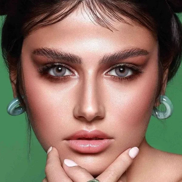 Close-up of Bella Elite Amber Gray Lenses on a neutral background, showcasing their subtle amber and gray tones.