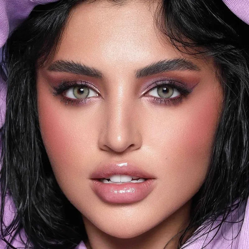 Close-up of Bella Elite Emerald Green Lenses, showcasing their vibrant green hue and subtle limbal ring.