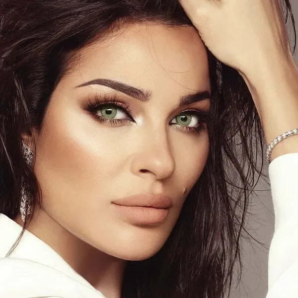 Close-up of Bella Elite Emerald Green Lenses, showcasing their vibrant green hue and subtle limbal ring.