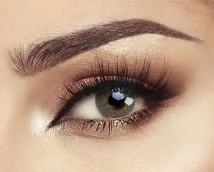 Bella Elite Silky Green Lenses in a clear, open packaging, showcasing their vibrant green hue and smooth texture.