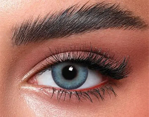 Close-up of Bella Glow Navy Gray Lenses, showcasing their subtle color and natural appearance on an eye.