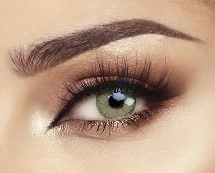 Bella Elite Emerald Green Lenses, showcasing a vibrant emerald green colored contact lens with a subtle limbal ring.