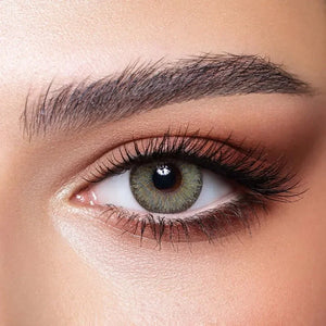 Bella Elite Emerald Green Lenses in a clear case, showcasing the vibrant green color.