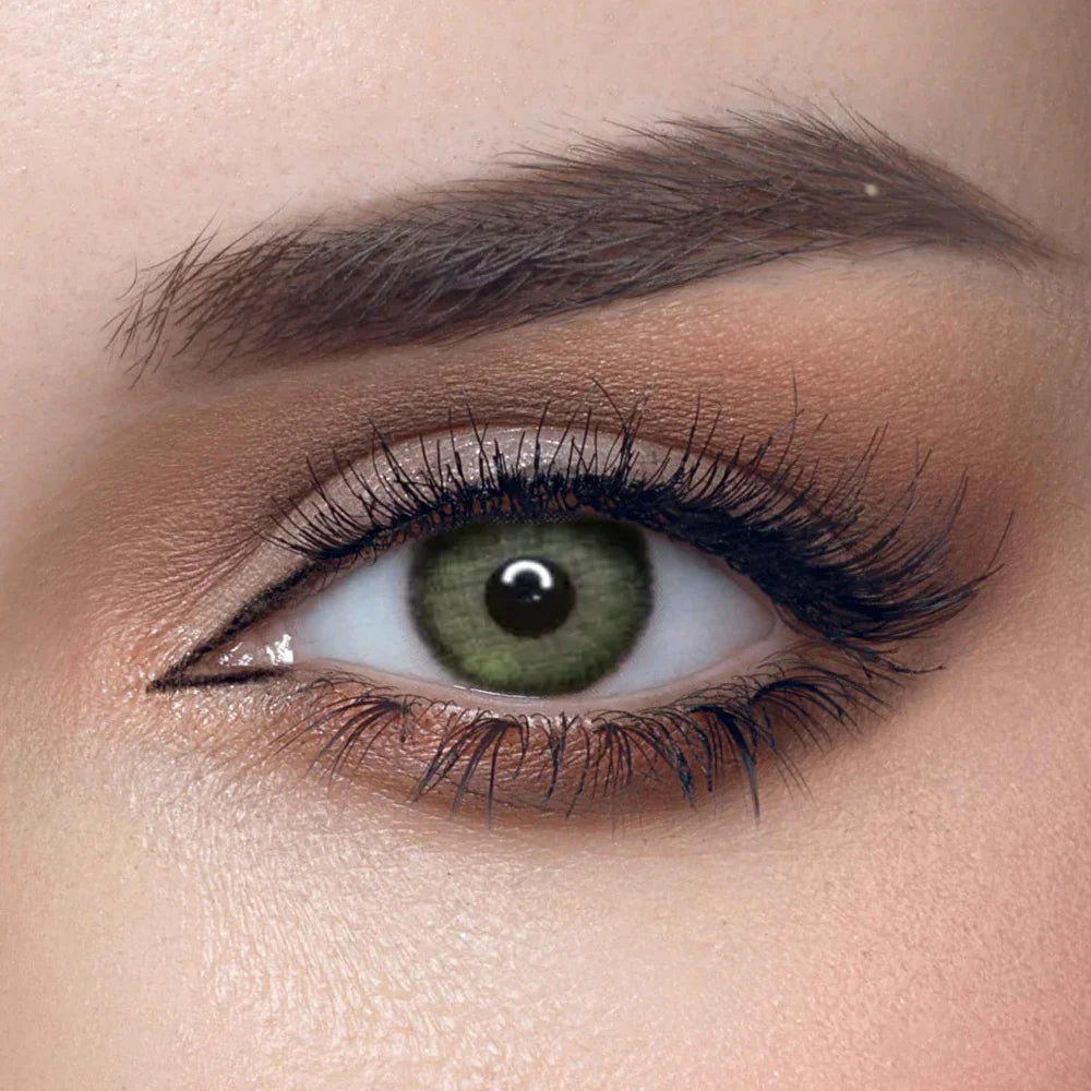 Solenza Silk Green Color Contact Lenses, showing one green-tinted lens on a white surface.