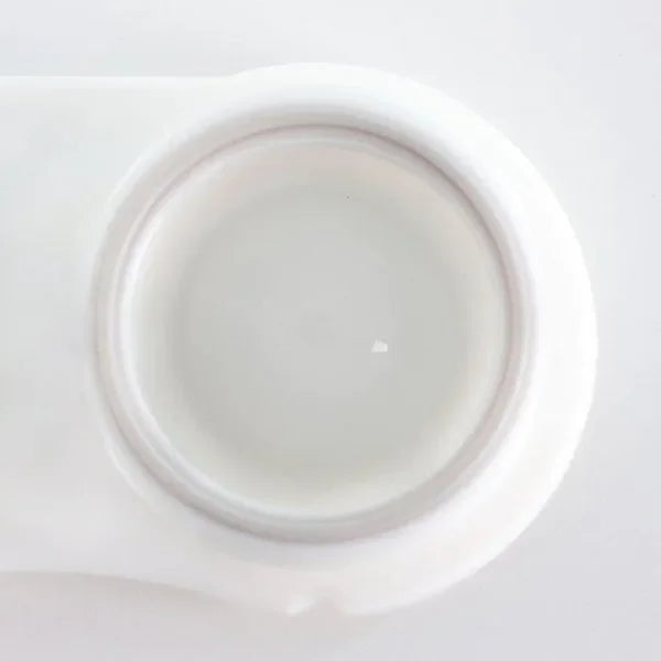 Close-up of a pair of Blind White Halloween Lenses, showcasing their opaque white, pupil-less design.