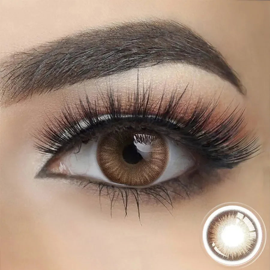 Savage Brown (1-Year) Color Lenses: A close-up of a single brown contact lens with a natural, subtle brown hue.