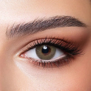 Bella Elite Silky Green Lenses in a clear case, showcasing their vibrant green hue and subtle pattern.
