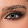 DYE Silver Lace Monthly Lenses by Bella, showcasing a single cosmetic contact lens with a delicate silver lace pattern.