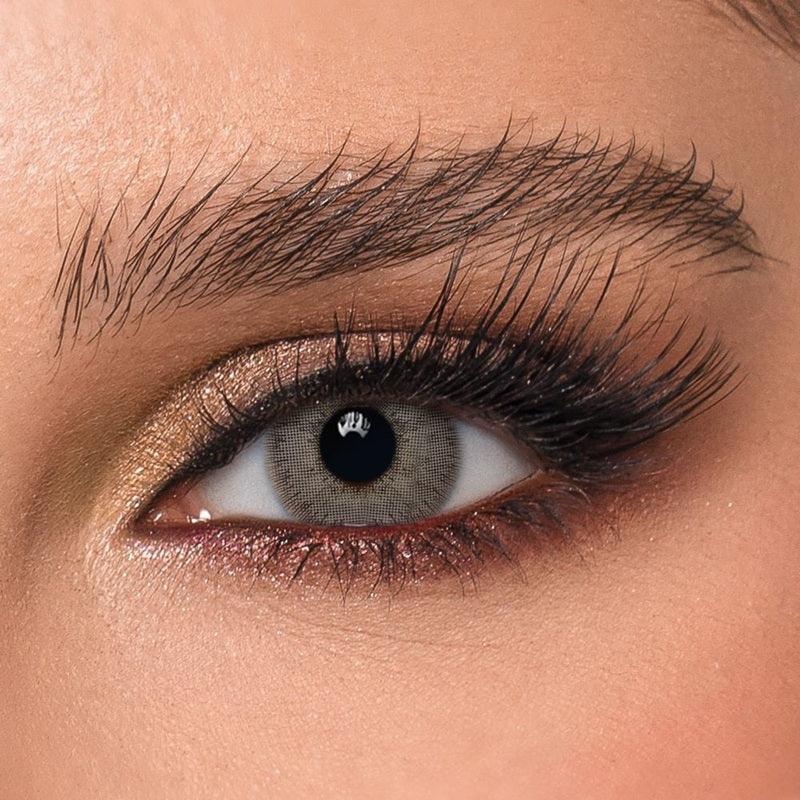DYE Silver Lace Monthly Lenses by Bella, showcasing a single cosmetic contact lens with a delicate silver lace pattern.
