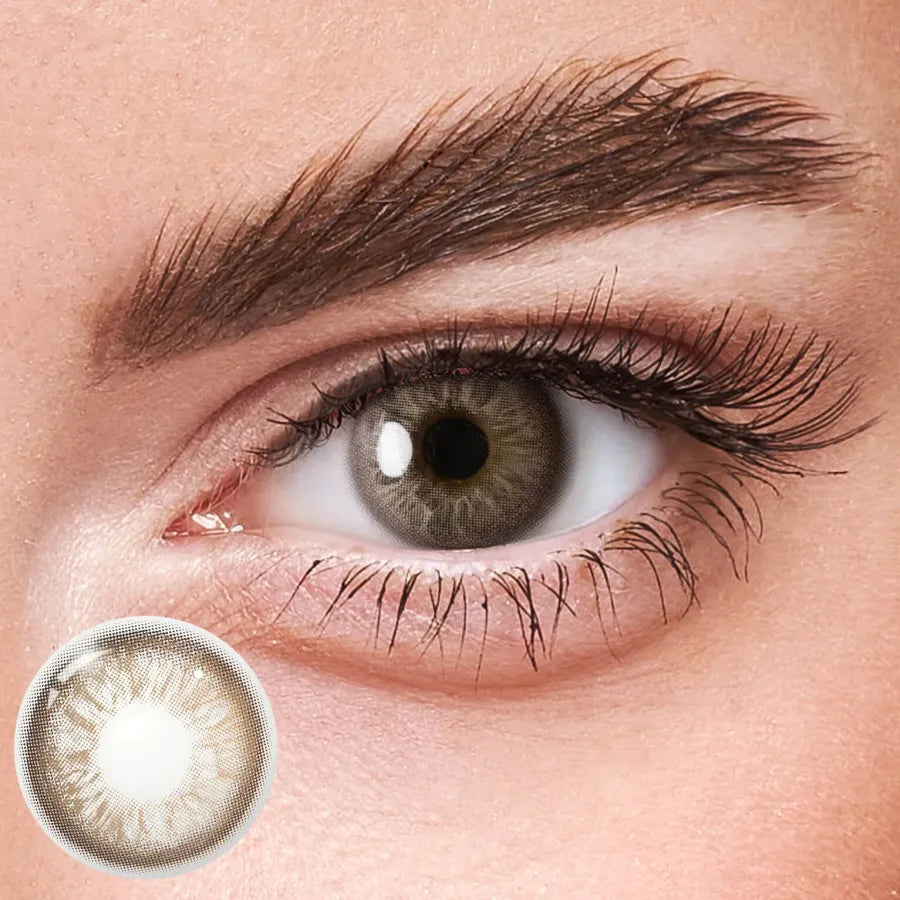 Unspoken Brown yearly contact lenses, showcasing a natural brown iris with subtle highlights.