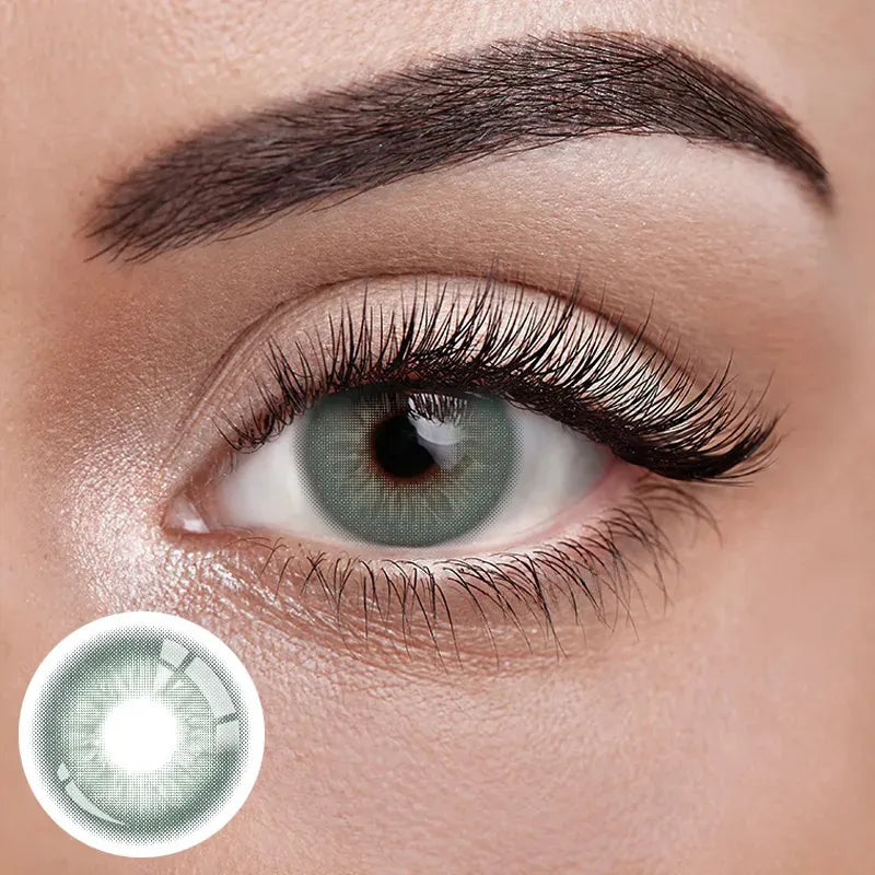 Unspoken Green 1 Yearly Lenses, a pair of vibrant green contact lenses on a white background.