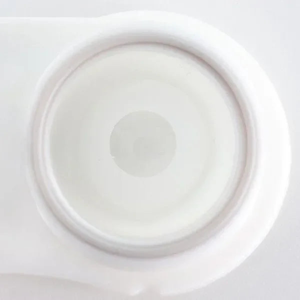 Close-up of white out Halloween lenses, creating a solid white, opaque eye effect.